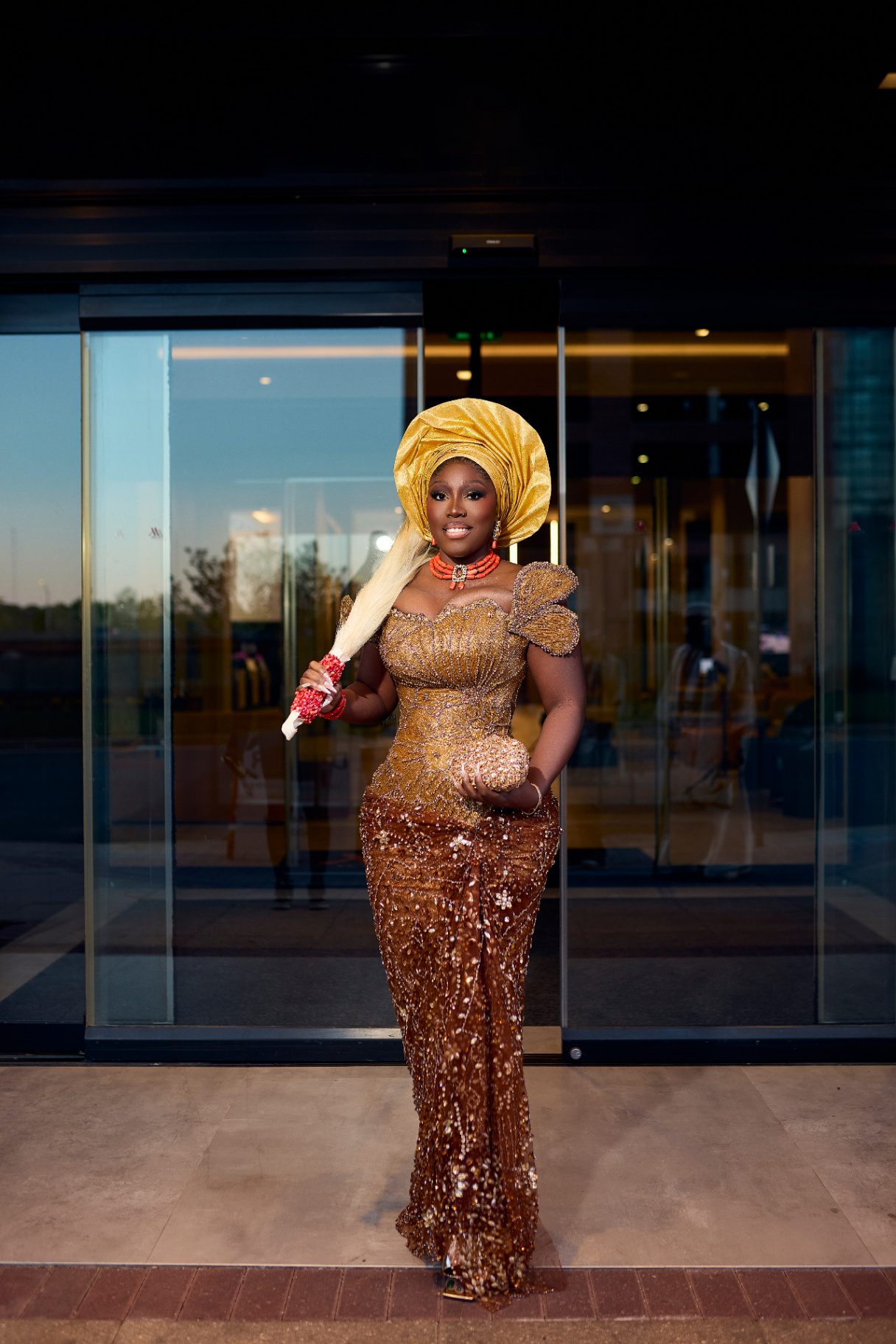 Mary in traditional gold gele and beaded attire
